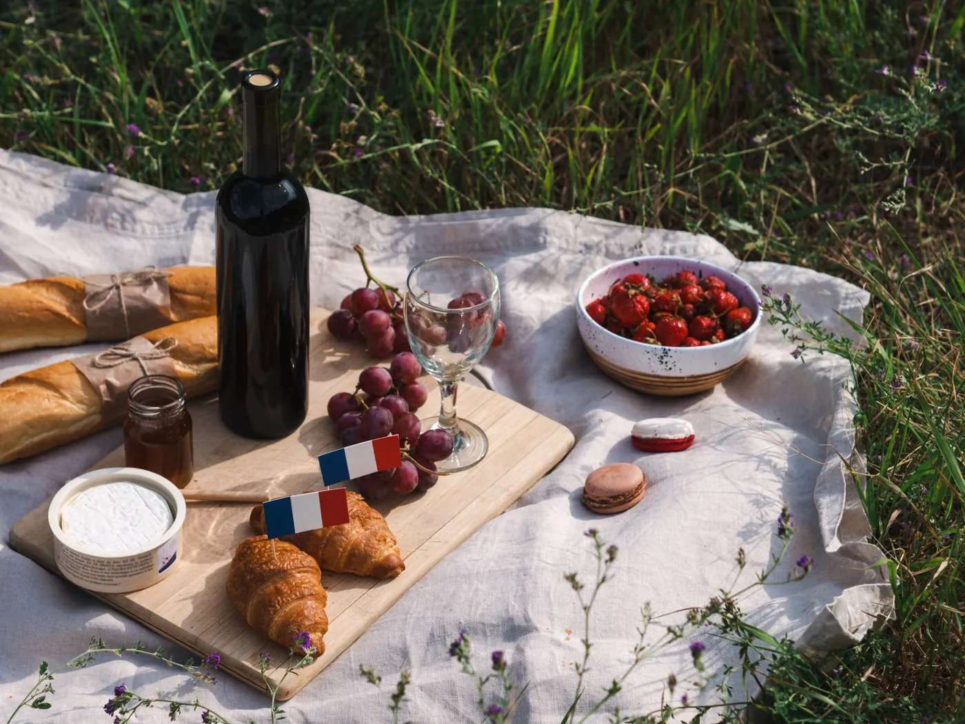 A French picnic with croissants, cheese, fruit and macarons