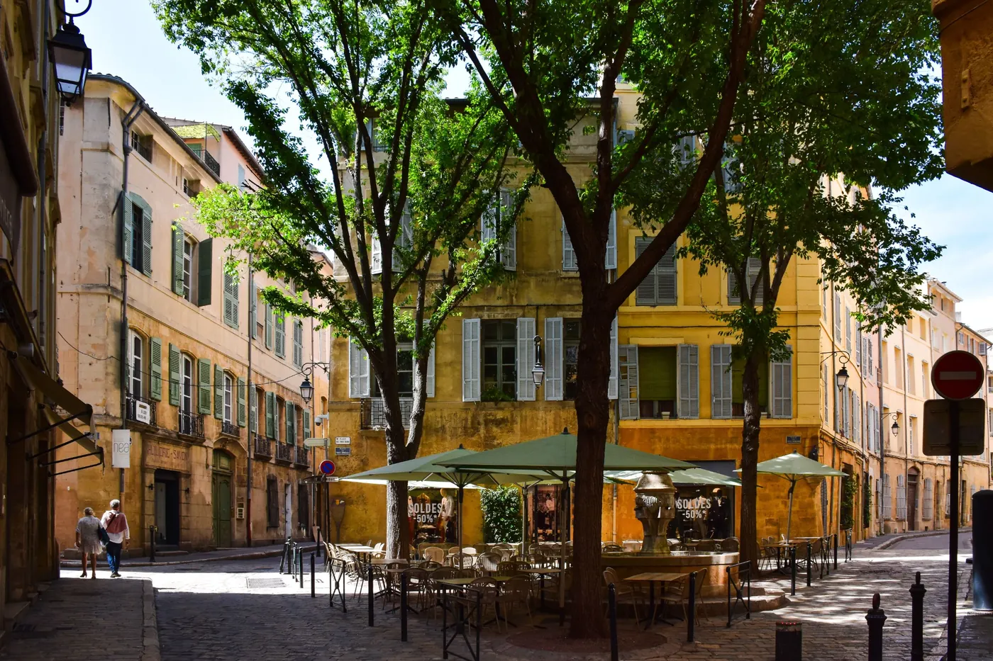 A shaded café square and warm ochre façades in Provence